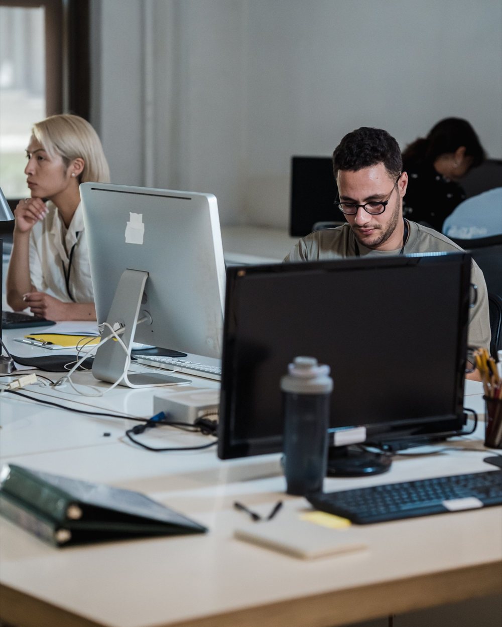 Engineers working at their desktop workstations in an open-plan office